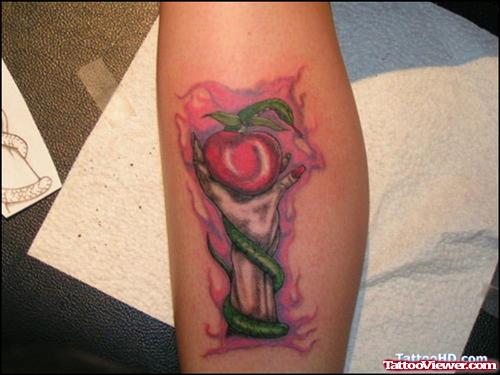Red Apple In Hand Tattoo On Arm