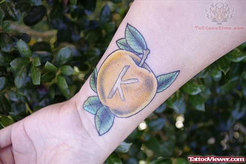 Yellow Apple Tattoo On Wrist
