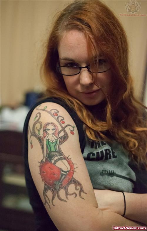 Doll And Apple Tree Tattoo On Bicep