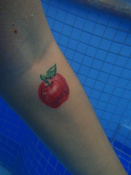 Red Ink Apple Tattoo On Arm