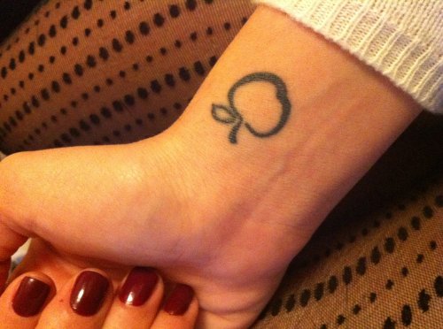 Small Apple Tattoo On Girl Right Wrist