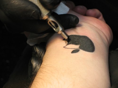 Amazing Black Ink Apple Logo Tattoo on Left Wrist