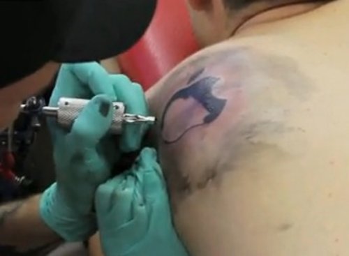 Apple Tattoo On Left Back Shoulder