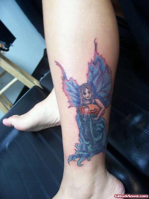 Blue Ink Colored Fairy Aquarius Tattoo On Leg
