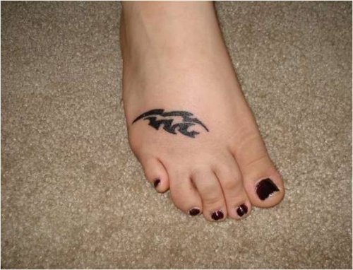 Black Tribal Aquarius Tattoo On Girl Right Foot