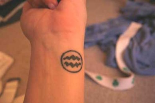 Black Tribal Aquarius Tattoo On Wrist