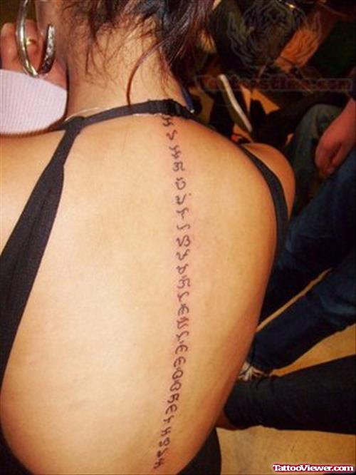 Arabic Tattoo On Girl Back Bone