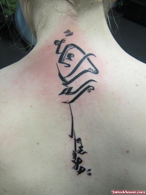 Black Ink Arabic Tattoo On Upperback