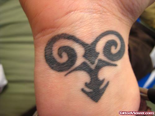 Black Ink Aries Tattoo On Wrist