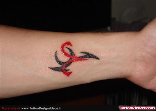 Red And Black Tribal Aries Tattoo on Left Forearm