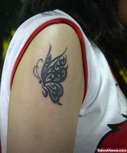 Black Ink Tribal Butterfly Arm Tattoo
