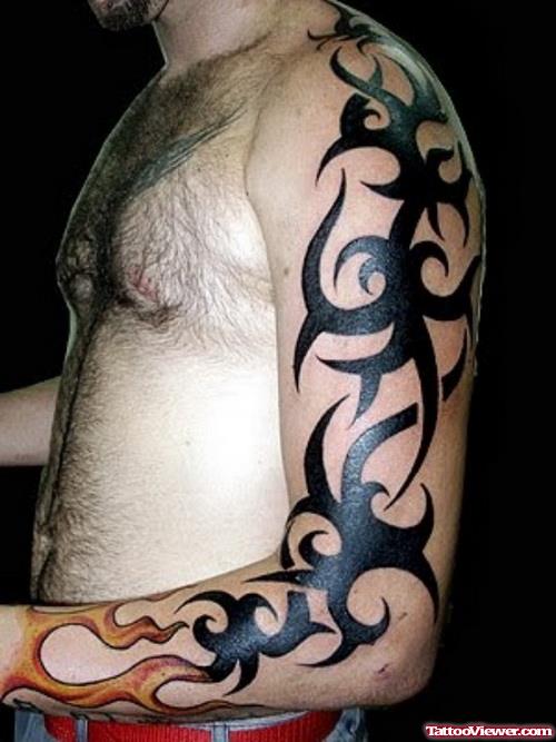 Flame And Tribal Tattoo On Man Left Arm