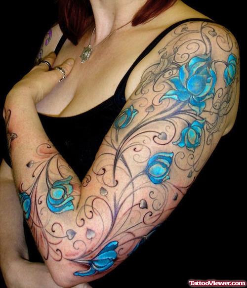 Blue Ink Flowers Tattoo On Left Arm