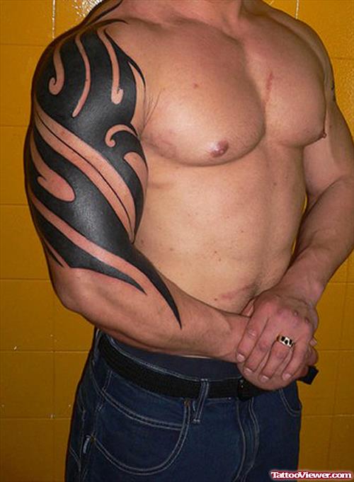 Black Ink Tribal Tattoo On Man Right Sleeve