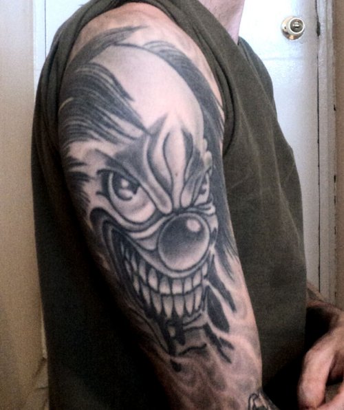 Grey Ink Joker Head Tattoo On Right Sleeve
