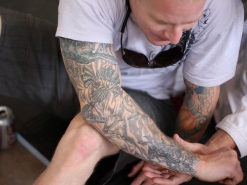 Grey Ink Tattoo On Man Full Arm