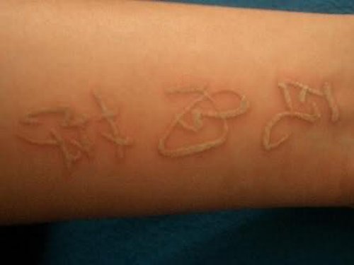 White Ink Words Tattoo On Arm