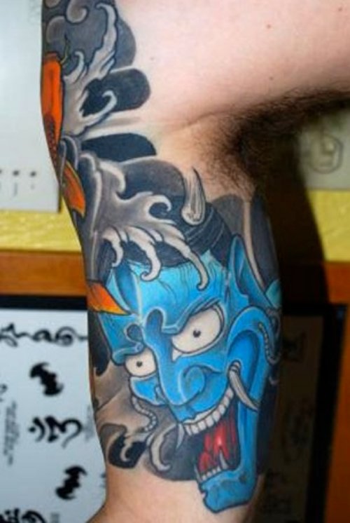 Blue Ink Demon Head Tattoo On Arm