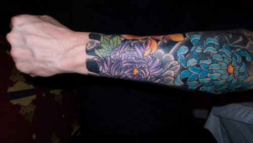 Colored Flowers Left Arm Tattoo