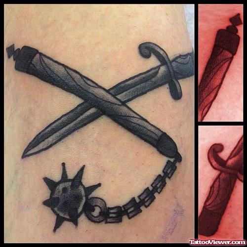 mace and sword on arm tattoo