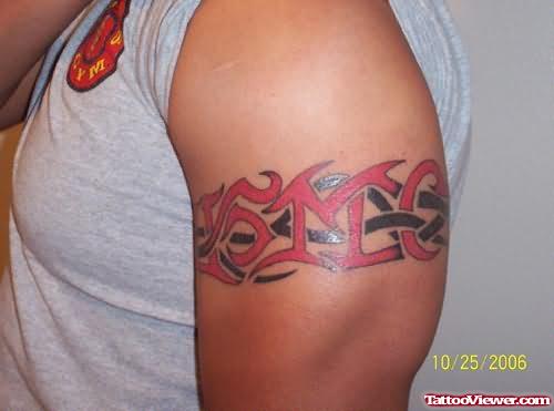 Red And Black Tribal Armband Tattoo On Left Arm