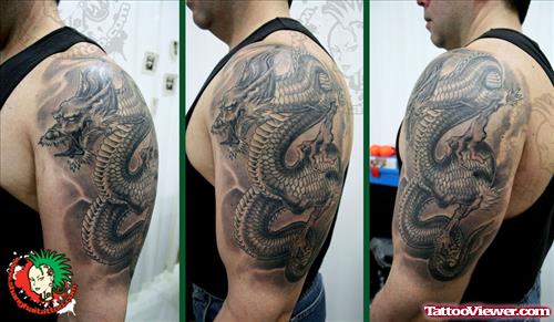 Grey Ink Asian Tattoo On Man Left Half Sleeve