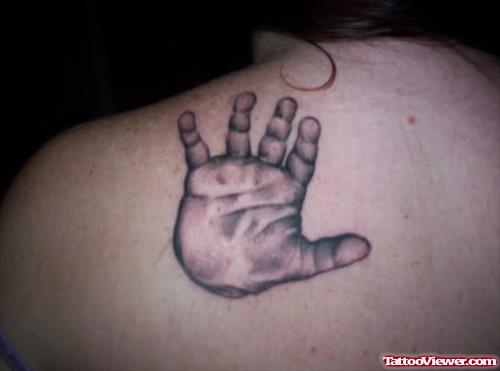 Small Baby Hand Tattoo On Left Back Shoulder