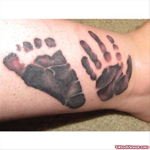 Hand And Footprint Tattoo On Right Leg