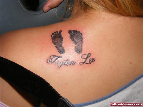 Girl With Baby Feet Tattoo On Back