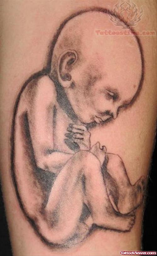 Grey Ink Sleeping Baby Tattoo On Arm