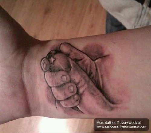 Grey Ink Baby Hand Tattoo On Wrist