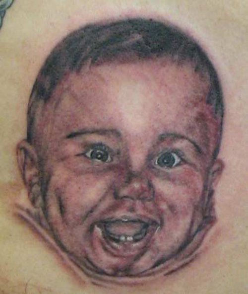 Grey Ink Smiling Baby Head Tattoo