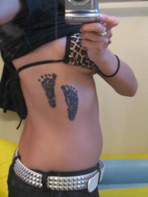 Girl Showing Her Baby Footprints Tattoos
