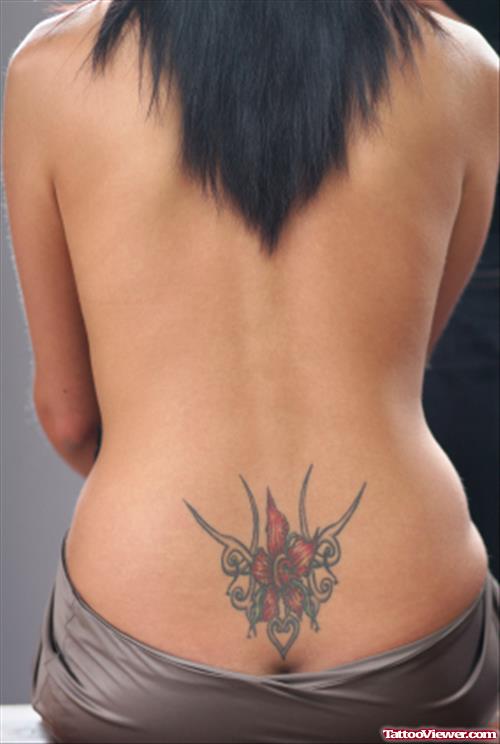 Red Flower And Tribal Lower Back Tattoo For Girls