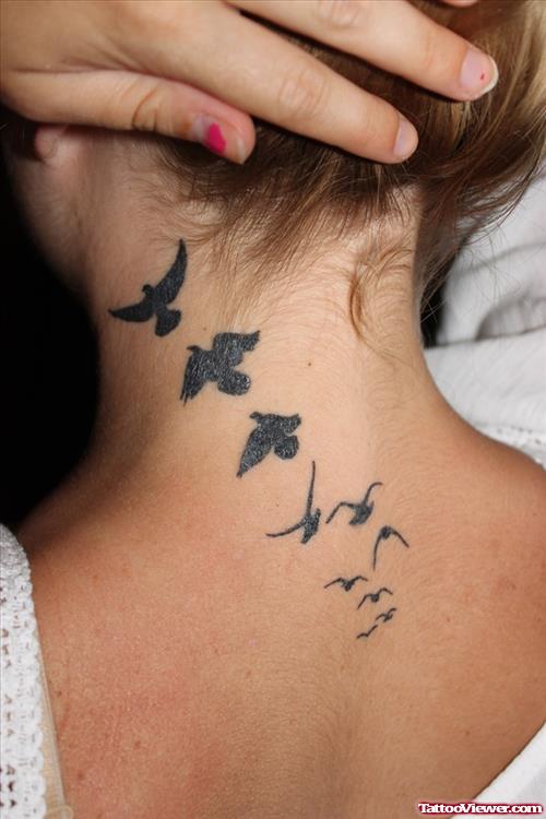 Black Ink Flying Birds Tattoo On Girl Upperback