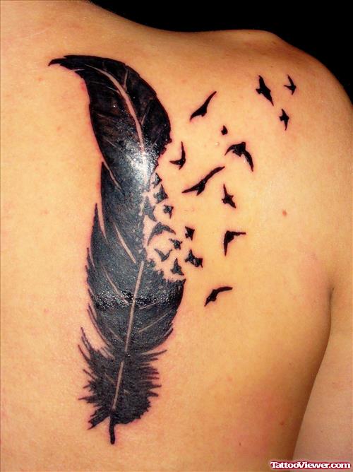 Awesome Black Ink Birds Flying From Feather Back Tattoo