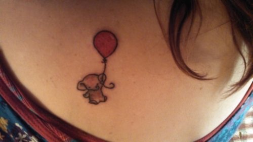 Tiny Elephant With Red balloon Tattoo On Chest