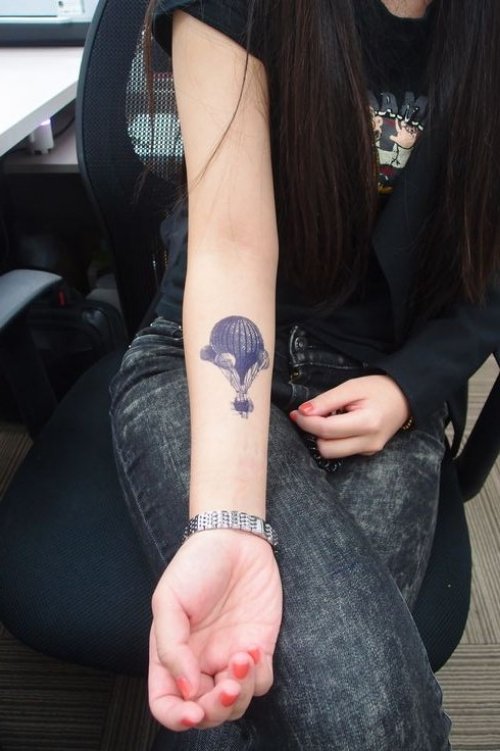 Girl Showing Her Balloon Tattoo On Right Forearm