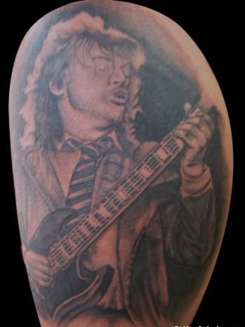 Man Playing Guitar Tattoo On Shoulder