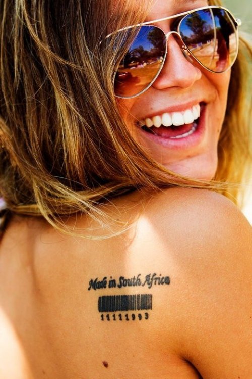 Smiling Girl With Barcode Tattoo On Right Back Shoulder