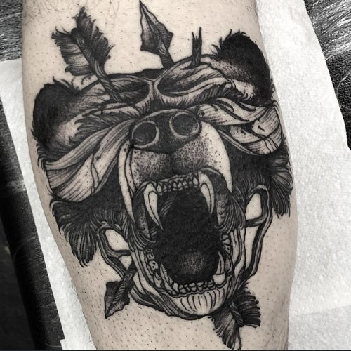 Arrows Pierced In Bear Head Tattoo On Leg