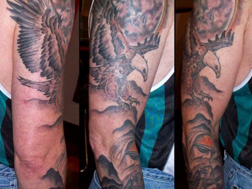 Grey Ink Flying Eagle Tattoo On Sleeve