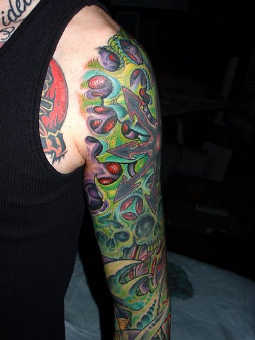 Green Ink Biomechanical Tattoo On Man Left Sleeve