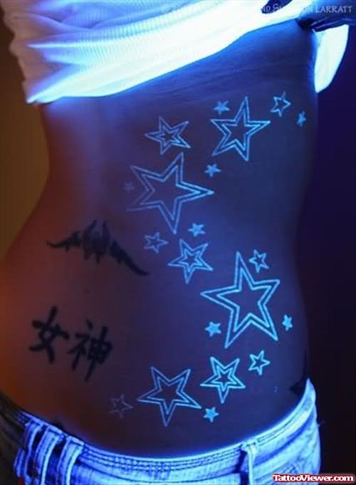 Stars Black Light Tattoo On Rib