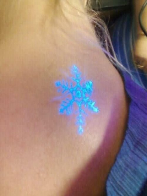 Blue Snow Flake Black Light Tattoo On Side Neck