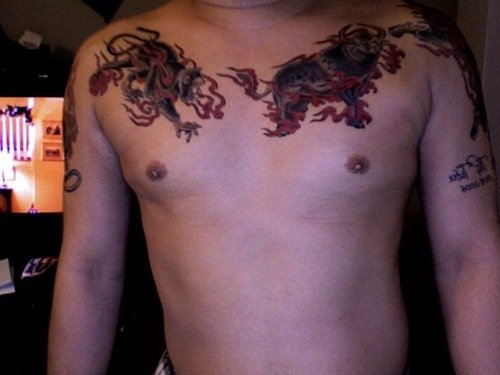 Red Flames and Boar Tattoos On Man Chest