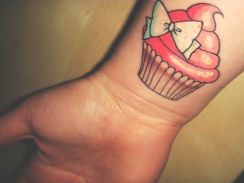 Colored Cupcake And Bow Tattoo