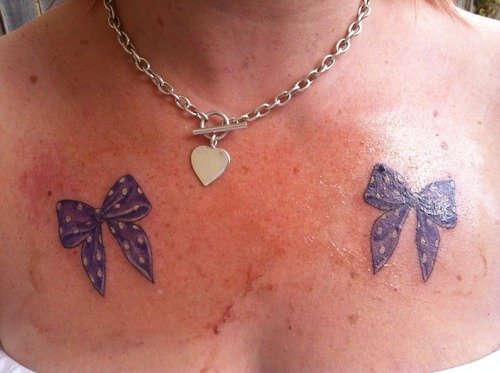 Purple Ink Bow Tattoos On Front Shoulders