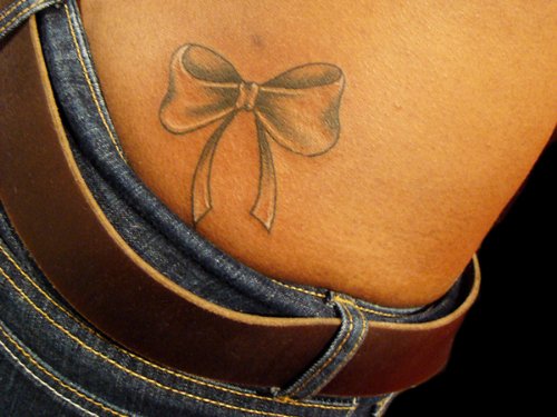 Grey Bow Tattoo On Lower Back