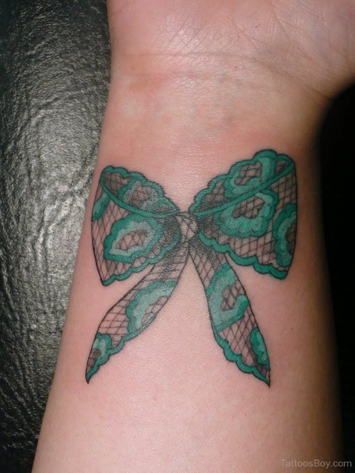 Green Lace Bow Tattoo On Right Wrist